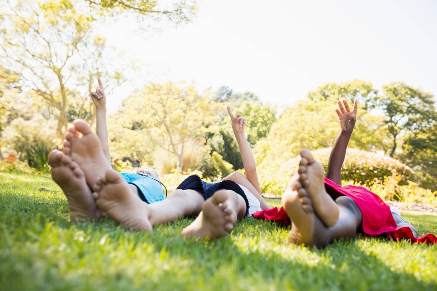 Friends on grass lying.